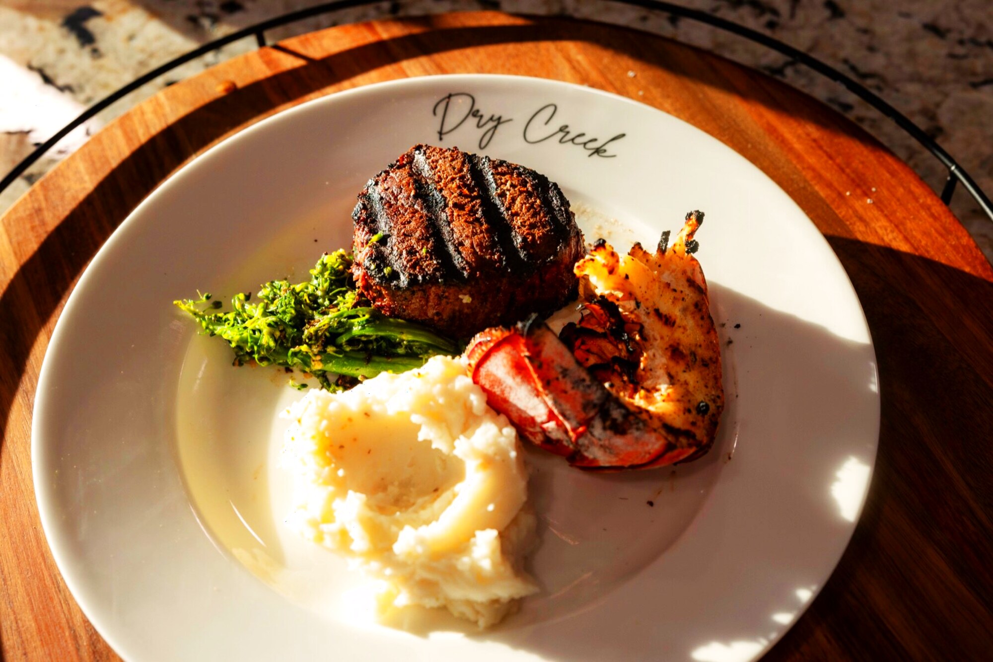 Grilled steak and lobster on a Dry Creek-branded plate