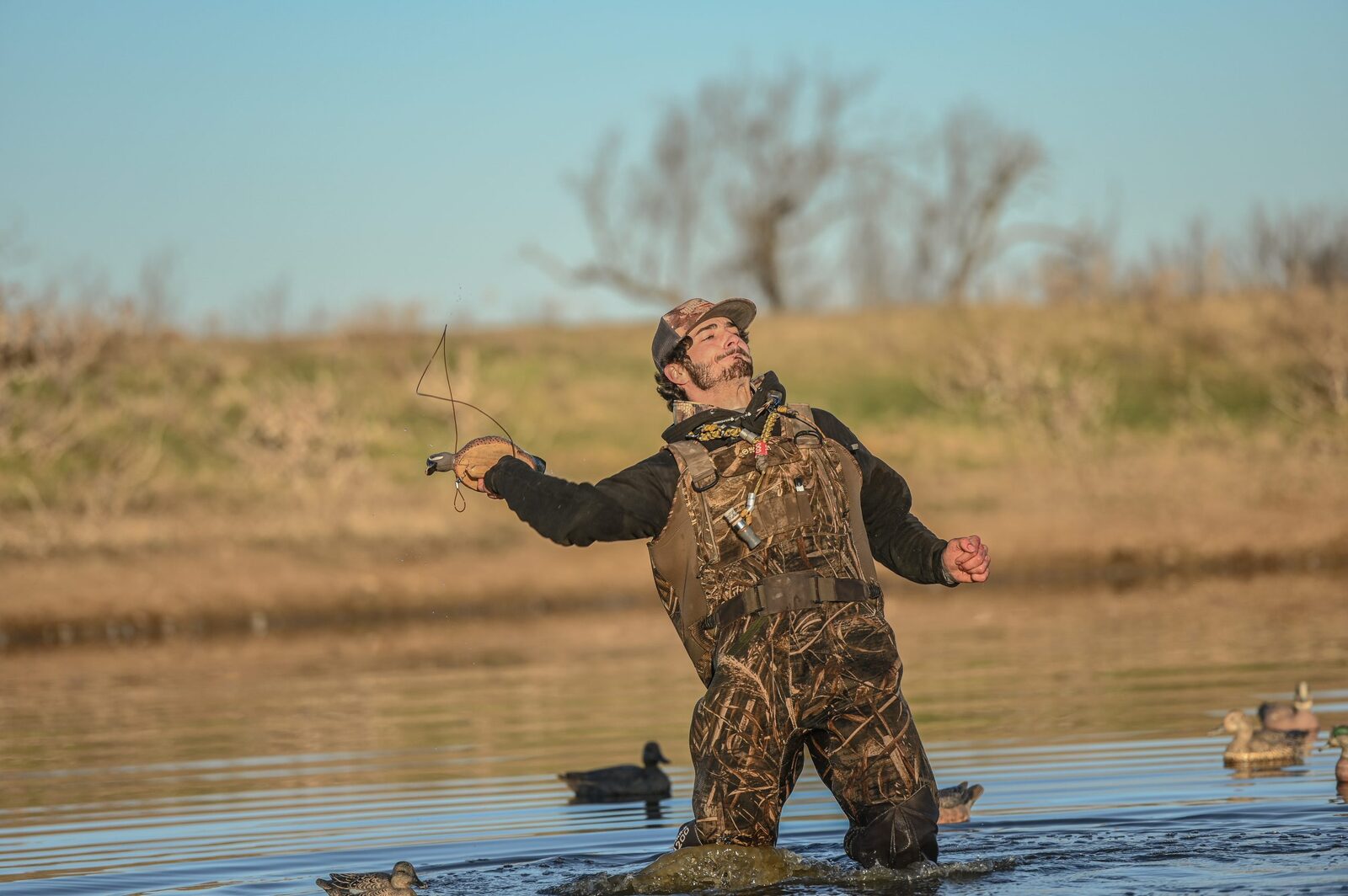 Hunters working a waterfowl spread at first light