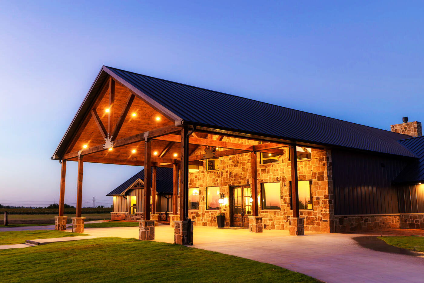 The covered porch and timber entry at dusk