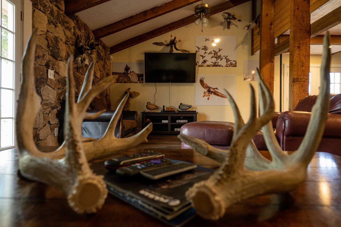 A bedroom under wood beams at Pecan Creek